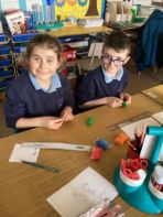 Year 4/5 using their modelling skill to create a clay ‘red eyed tree frog’ as part of their rainforest topic