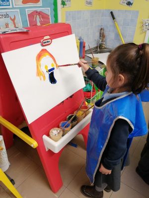 Mara wants to be a teacher when she is older. She is painting herself as a teacher!